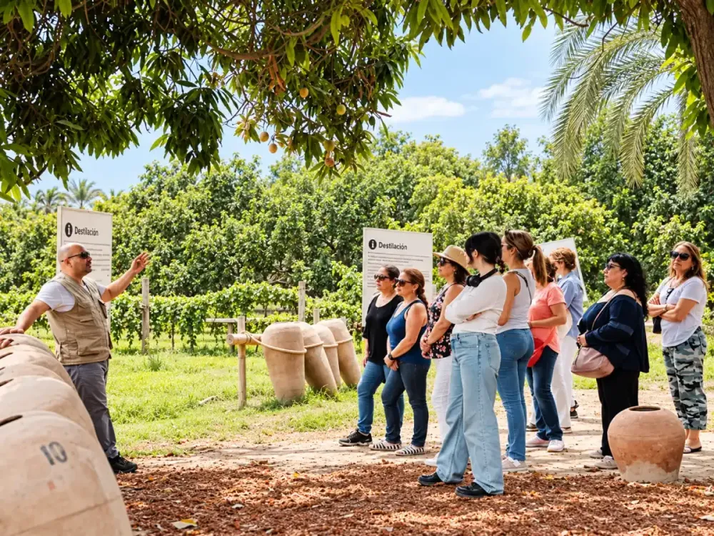 Turistas durante una visita guiada a una bodega de pisco en Ica, entre tinajas de barro y viñedos.