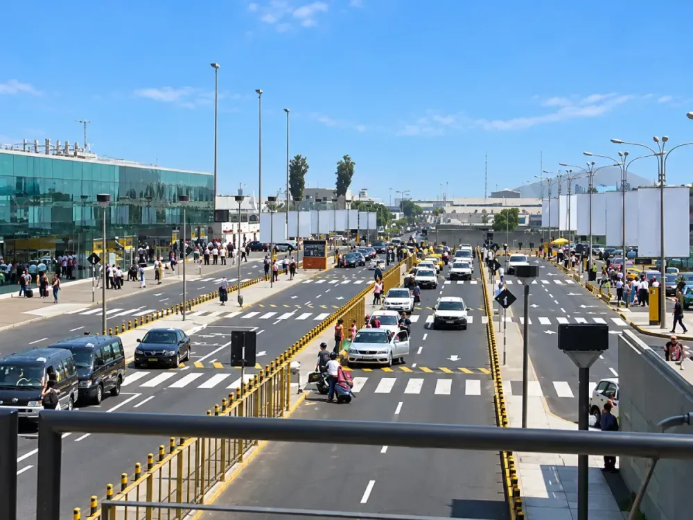 Tránsito de autos y personas en los exteriores de un aeropuerto moderno