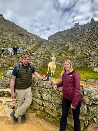Couple exploring Machu Picchu during their visit to Cusco, Peru