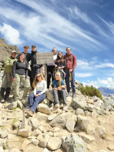 Group of travelers reaching Salkantay Pass during their trek in Cusco