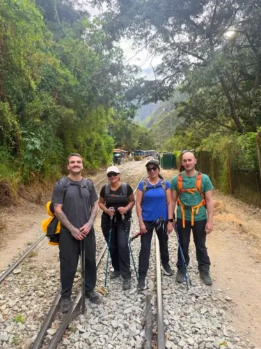 Group of travelers hiking along the railway route to Machu Picchu