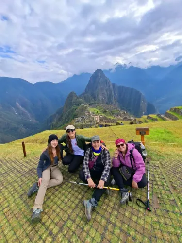 Group of female travelers enjoying Machu Picchu with Huayna Picchu in the background
