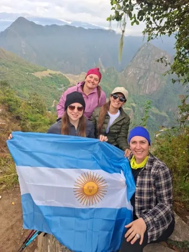 Group of travelers with the Argentine flag on their journey to Machu Picchu